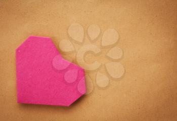 Hand made paper heart on kraft paper as background. Greeting car. Free space for text