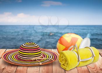 Wooden table with beach items, blur sea on background, template design