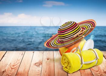 Wooden table with beach items, blur sea on background, template design