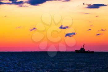 Fishing ship at sea with sunset 