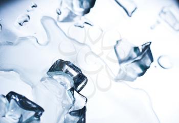 Abstract background with ice cubes over wet glass 
