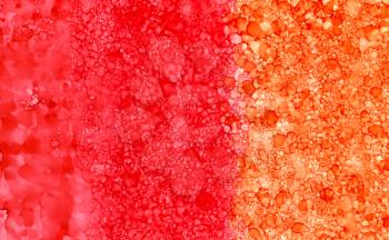 Abstract backdrop red orange smudges.Colorful painted background hand drawn with bright inks and watercolor paints. Bright color splashes and splatters create uneven artistic background.