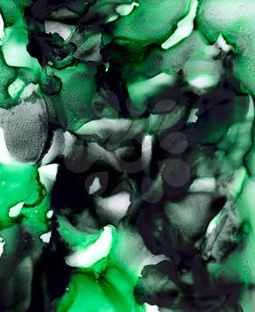 Abstract paint black green merging uneven.Colorful background hand drawn with bright inks and watercolor paints. Color splashes and splatters create uneven artistic modern design.