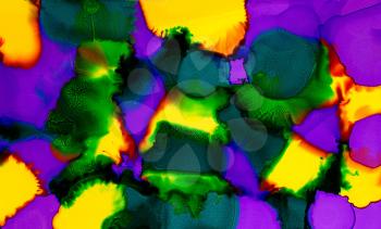 Abstract paint yellow purple green spots merging.Colorful background hand drawn with bright inks and watercolor paints. Color splashes and splatters create uneven artistic modern design.