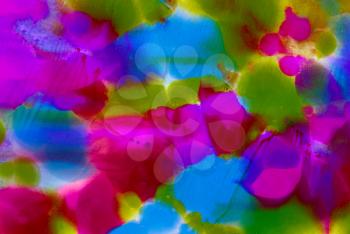 Abstract smudged painted purple blue green spots.Colorful background hand drawn with bright inks and watercolor paints. Color splashes and splatters create uneven artistic modern design.