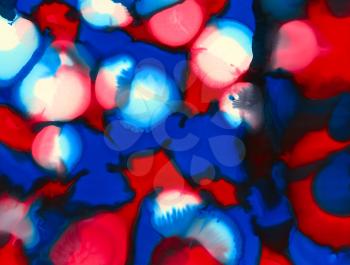 Red blue white black uneven color merging spots.Colorful background hand drawn with bright inks and watercolor paints. Color splashes and splatters create uneven artistic modern design.