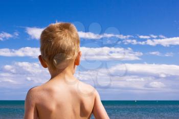 A blond young child on a beach