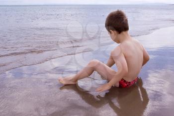 A Young child alone on the beach