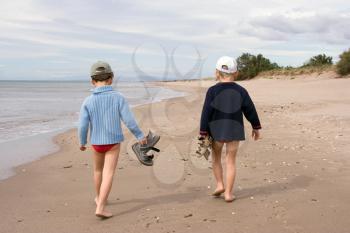 Two children walking on the beach