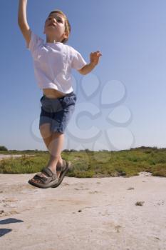 A young jumping child in the nature