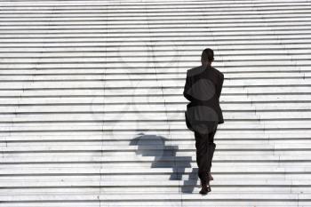 businessman climbing stairs