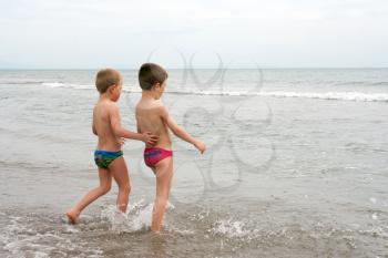 Two children playing on the beach