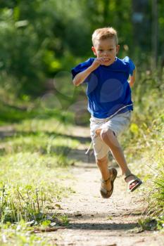 A Young boy running in nature