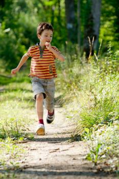 A Young boy running in nature