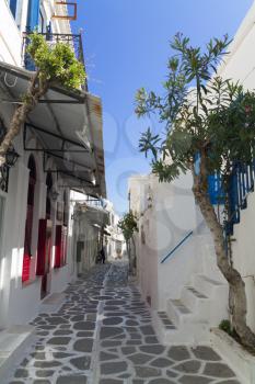 Classical Greek narrow street with a painted sidewalk in parikia