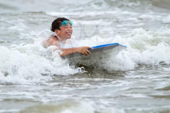 Young boy with a bodyboard on the beach