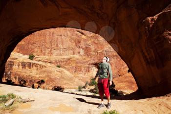 Royalty Free Photo of a Tourist in an Arch at Arches National Park in Utah