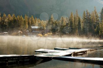 Royalty Free Photo of a Dock on Autumn Lake in Autumn