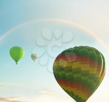Royalty Free Photo of Hot Air Balloons and a Rainbow