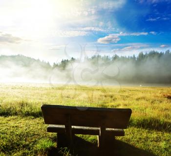 Royalty Free Photo of a Bench in a Field
