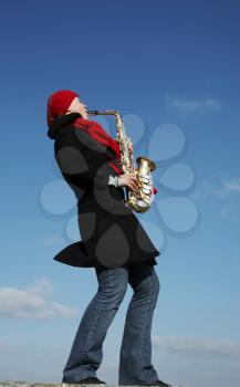 Royalty Free Photo of a Girl Playing a Saxophone