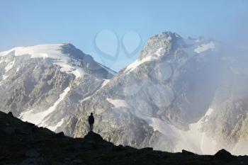 Royalty Free Photo of a Silhouette of a Boy in the Mountains