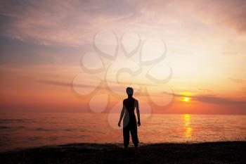 Royalty Free Photo of a Silhouette of a Boy on a Beach