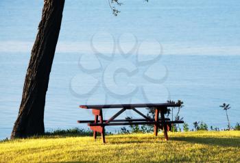 Royalty Free Photo of a Picnic Table Overlooking a Lake