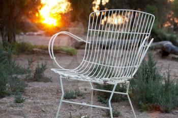 Royalty Free Photo of a Wire Chair and Sunset