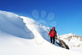 Royalty Free Photo of a Hiker on a Snowy Mountain