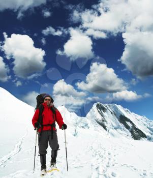 Royalty Free Photo of a Hiker on a Snowy Mountain