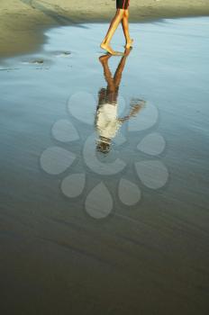 Royalty Free Photo of a Person Walking on an Indian Ocean Beach