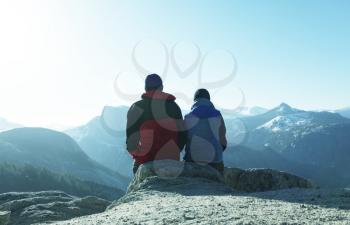 Royalty Free Photo of a Couple Sitting on a Mountain Top