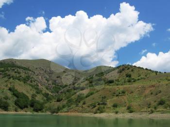 Royalty Free Photo of a Mountain Lake and Clouds