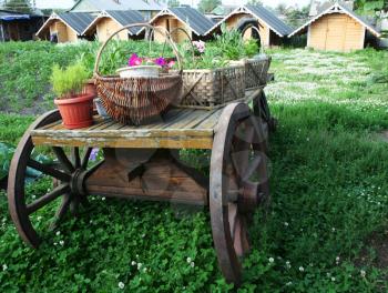 Royalty Free Photo of Baskets of Flowers on a Wagon