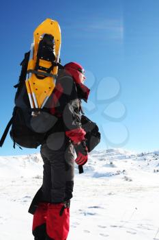 Royalty Free Photo of a Woman Hiking with Snowshoes