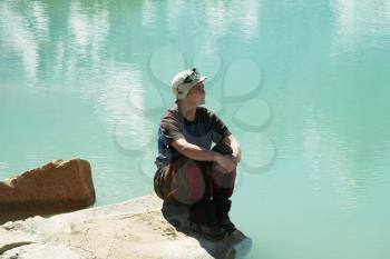 Royalty Free Photo of a Woman Relaxing Beside a Lake