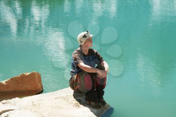 Royalty Free Photo of a Woman Resting Beside a Lake