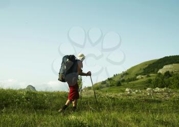 Royalty Free Photo of a Man Hiking in a Field