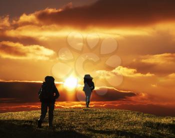 Royalty Free Photo of a Silhouette of Two People on a Trek