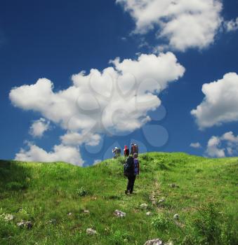 Royalty Free Photo of People Hiking in a Grassland