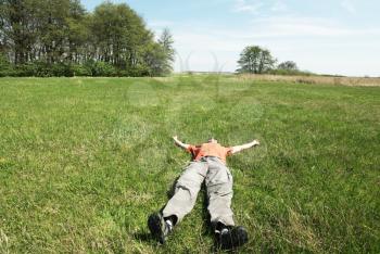 Royalty Free Photo of a Man Laying in Grass