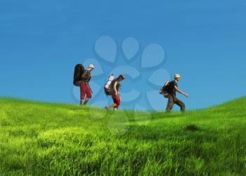 Royalty Free Photo of Three Hikers in Grassland
