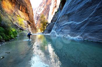 Royalty Free Photo of a Tourist in a Canyon Filled with Water