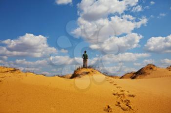 Royalty Free Photo of a Man Hiking in the Desert