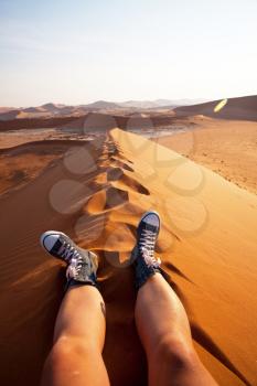 Royalty Free Photo of a Person Sitting in the Desert