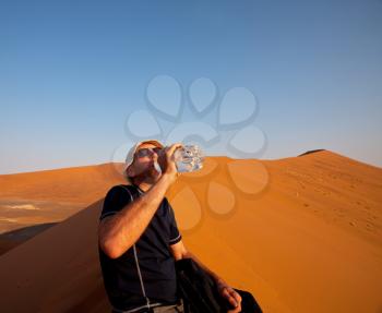 Royalty Free Photo of a Hiker in the Desert Drinking Water