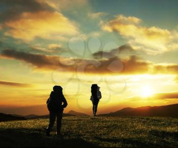 Royalty Free Photo of Backpackers at Sunset