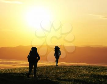 Royalty Free Photo of Backpackers at Sunset