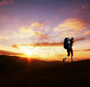 Royalty Free Photo of a Woman Hiking at Sunset